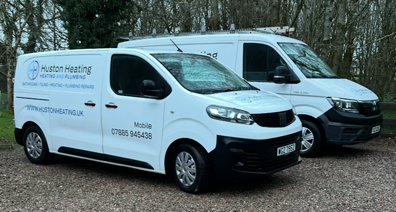 Two service vans parked outside